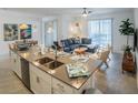 Open floor plan showcases a living room, dining area, and kitchen with modern finishes and ample natural light at 1160 Kingsbarn St, Davenport, FL 33896