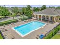 Inviting community pool with ample lounge seating and a covered pavilion at 13758 Daniels Landing Cir, Winter Garden, FL 34787