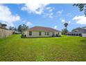 Spacious backyard with a well-maintained lawn and an exterior view of the house at 14091 Sw 32Nd Terrace Rd, Ocala, FL 34473