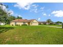 Exterior view of a cozy single-Gathering home with a lush green lawn at 14091 Sw 32Nd Terrace Rd, Ocala, FL 34473