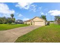 A bright single-Gathering home with a driveway and a well-manicured front lawn at 14091 Sw 32Nd Terrace Rd, Ocala, FL 34473