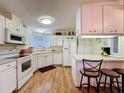 Traditional kitchen with white cabinetry, modern appliances, and breakfast bar at 143 Piedmont Park Ave, Davenport, FL 33897
