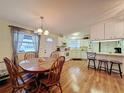 Open layout with kitchen, dining area and wood laminate floors at 143 Piedmont Park Ave, Davenport, FL 33897