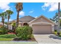 Charming single-story home boasting mature landscaping, two-car garage and neutral paint scheme at 1560 The Oaks Blvd, Kissimmee, FL 34746