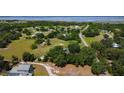 Expansive aerial view showcasing the property's large lot, mature trees, and proximity to a body of water at 1850 Orangewood Ave, St Cloud, FL 34772