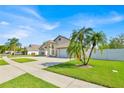 Well-manicured lawn with palms accentuates this beautiful home and its two-car garage at 2642 Gold Dust Cir., Kissimmee, FL 34744
