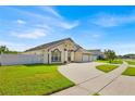 Beautiful single-story home featuring a well-manicured lawn and an attached two-car garage at 2642 Gold Dust Cir., Kissimmee, FL 34744
