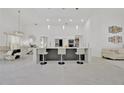 Bright open kitchen with modern white cabinetry, a large island, and pendant lighting at 2642 Gold Dust Cir., Kissimmee, FL 34744