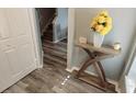 Inviting foyer boasts wood-look floors, stylish console table, and staircase at 2729 Club Cortile Cir, Kissimmee, FL 34746