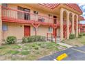 Condo complex with red roof, balconies, and parking space, showcasing its inviting design at 2864 N Powers Dr # 150, Orlando, FL 32818