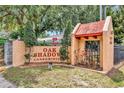 Oak Shadow Condominiums sign, accented with lush landscaping and a secure gated entrance at 2864 N Powers Dr # 150, Orlando, FL 32818