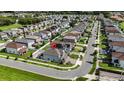 Aerial view of a home's location in a neighborhood with tree-lined streets and nearby amenities at 2922 Crest Dr, Kissimmee, FL 34744