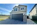 Two-story home featuring a paved driveway and large two-car garage at 2922 Crest Dr, Kissimmee, FL 34744