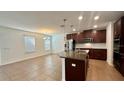 Open kitchen featuring stainless steel appliances, granite countertops, and a breakfast bar at 2922 Crest Dr, Kissimmee, FL 34744