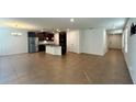 Open floor plan combining the kitchen, dining, and living room areas with tile flooring at 2922 Crest Dr, Kissimmee, FL 34744