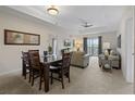 Cozy living and dining area with comfortable seating, ceiling fan, and a view from the sliding glass doors at 3060 Pirates Retreat Ct # 309, Kissimmee, FL 34747