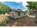 Side view of a charming house with a shed and well-maintained yard at 308 Forest St, Fruitland Park, FL 34731
