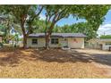 Cozy single-story home with mature trees, offering shade and curb appeal at 308 Forest St, Fruitland Park, FL 34731