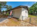 The side of the house has fresh paint, a well-kept yard, and a chain-link fence at 308 Forest St, Fruitland Park, FL 34731