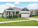 Beautiful single-Gathering home boasting a spacious two-car garage, and professional landscaping at 3443 Florigold Grove St, Clermont, FL 34711