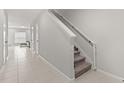 Bright hallway with tile floors, stairway, and view of the living room at 352 Smugglers Way, Apopka, FL 32712