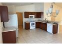 Bright kitchen with stainless steel appliances, tile floor, and plenty of counter space at 369 St Georges Cir, Eagle Lake, FL 33839