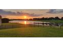 Beautiful sunset view overlooking the lake from the lush green backyard at 3881 Shoreside Dr, Kissimmee, FL 34746