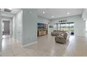 Spacious living room with neutral tile flooring, sliding glass doors to the exterior, and stylish modern decor at 3881 Shoreside Dr, Kissimmee, FL 34746