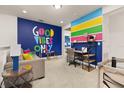 A colorful sitting room featuring a sofa, desk and playful decor at 420 Burma St, Kissimmee, FL 34747