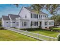 Expansive lawn and manicured hedges accent this home's exterior at 423 Arbor Cir, Celebration, FL 34747