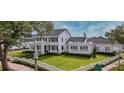 Expansive lawn and manicured hedges accent this home's exterior at 423 Arbor Cir, Celebration, FL 34747