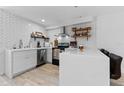 Bright kitchen featuring white cabinets, quartz countertops, subway tile backsplash, and stainless steel appliances at 5234 Eaglesmere Dr # D04, Orlando, FL 32819
