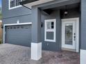 A beautiful covered entryway with a decorative front door and a gray color scheme at 5768 Los Palma Vista Dr, Orlando, FL 32837