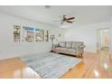 Bright living room features hardwood floors, plantation shutters, and neutral decor at 606 N Mcdonald St, Mount Dora, FL 32757