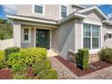Charming entryway with a green front door, brick pathway and well-maintained landscaping at 6080 Fender Ct, Orlando, FL 32837