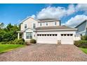 Beautiful two-story home with a three car garage and brick paver driveway at 6080 Fender Ct, Orlando, FL 32837