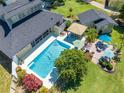 Aerial view of the private backyard pool with multiple seating areas at 6464 Timberwind Pl, Orlando, FL 32818