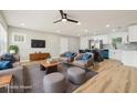 This living room features hardwood floors, modern furniture, and is open to the kitchen at 918 Louise Ln, Deland, FL 32720