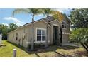 Charming two-story home with landscaped front yard and beautiful palm trees at 979 Hacienda Cir, Kissimmee, FL 34741