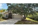 Charming two-story home featuring a well-manicured lawn and a two-car garage at 979 Hacienda Cir, Kissimmee, FL 34741