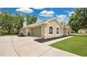 Side view of a home with a spacious driveway and attached garage at 101 Majestic Forest Run, Sanford, FL 32771