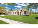 Lovely one-story home featuring a lush green lawn and inviting curb appeal at 101 Majestic Forest Run, Sanford, FL 32771