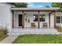 Close-up of the home's front porch with a patterned patio and comfortable seating area at 1012 N Shine Ave, Orlando, FL 32803