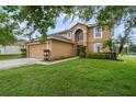 Charming two-story home with a well-manicured lawn and two car garage at 102 Royalty Cir, Sanford, FL 32771
