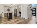 Open kitchen and entrance featuring updated appliances and wood flooring at 102 Royalty Cir, Sanford, FL 32771
