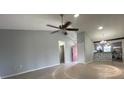 Open-concept living area with a ceiling fan, neutral walls, and lots of light at 116 Talavera Ln, Kissimmee, FL 34758