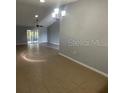 Bright living room featuring tile flooring, ceiling fan, and access to the lanai at 116 Talavera Ln, Kissimmee, FL 34758