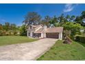 Charming two-story home features a front lawn, large trees and a two car garage at 120 W Minnehaha Ave, Clermont, FL 34711