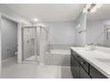 Clean bathroom features double vanity, shower, and soaking tub with decorative tile surround at 14160 Dove Hollow Dr, Orlando, FL 32824