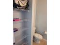 Bathroom area features shelving and a standard toilet at 153 Pompano Beach Dr Dr, Kissimmee, FL 34746